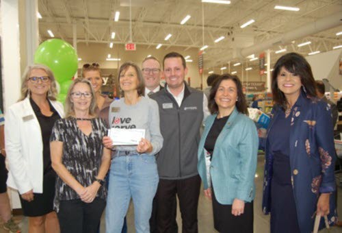 Society of Samaritans (SOS) received a $10,000 donation from Woodforest Charitable Foundation. Pictured are Beverly Points, SOS Secretary & Financial Counselor (holding check), Becky Benham, SOS Executive Director (3rd from left), and Tammy Teale, SOS Assistant Executive Director (2nd from left), along with Woodforest’s Brett Simms, Assistant VP & Branch Manager (center), and Julie Mayrant, President, and Chief Retail Officer (2nd from right), along with other bank team members.